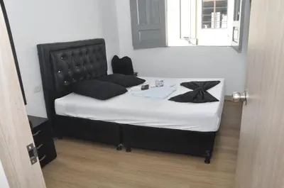 a bedroom with a bed with a black headboard at El ensueño in Manizales