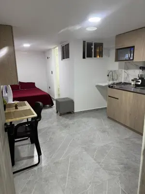 a room with a kitchen and a living room at Villa Loreto Aparta estudio 203 in Medellín