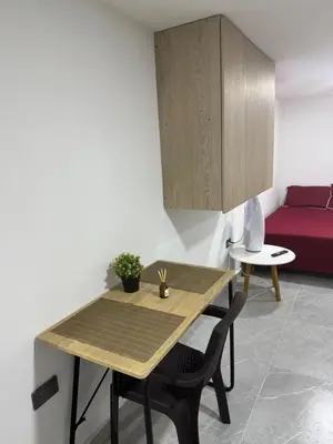 a kitchen with a wooden table and a red couch at Villa Loreto Aparta estudio 203 in Medellín