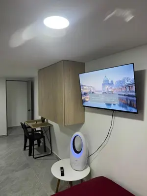 a room with a flat screen tv on the wall at Villa Loreto Aparta estudio 203 in Medellín
