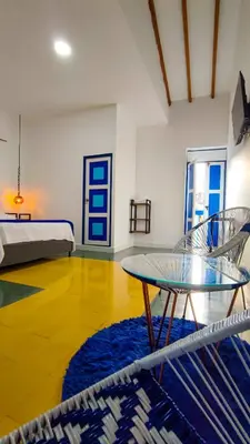 a room with a glass table and two chairs at Hotel Colonial San Roque in San Roque
