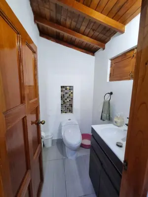 a bathroom with a toilet and a sink at Good Vibes El Víboral in Carmen de Viboral