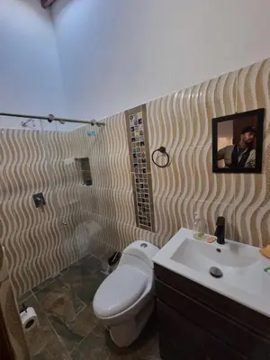 a bathroom with a toilet and a sink at Good Vibes El Víboral in Carmen de Viboral