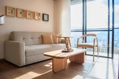 a living room with a couch and a table and a chair at Altura y Confort en Envigado in Envigado