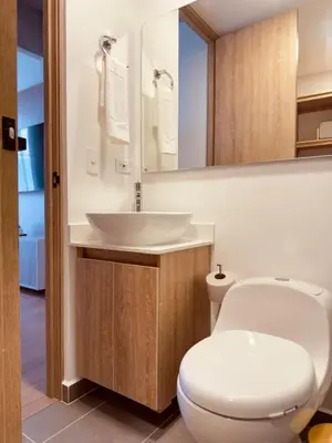 a bathroom with a white toilet and a sink at Altura y Confort en Envigado in Envigado
