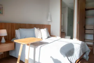 a bedroom with a bed and a wooden table at Altura y Confort en Envigado in Envigado