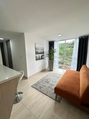 a living room with a couch and a table at Apartamento Moderno Sabaneta Wifi 600mb in Sabaneta