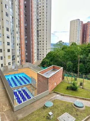 a swimming pool on top of a building with tall buildings at Apartamento Moderno Sabaneta Wifi 600mb in Sabaneta