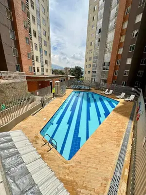 an empty swimming pool in the middle of two buildings at Apartamento Moderno Sabaneta Wifi 600mb in Sabaneta