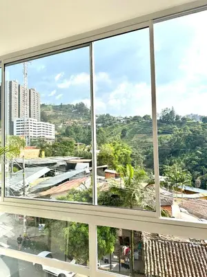 a window with a view of a city at Apartamento Moderno Sabaneta Wifi 600mb in Sabaneta