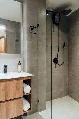 a bathroom with a shower with a glass door at Edificio Boutique Alori 15-3 in Medellín
