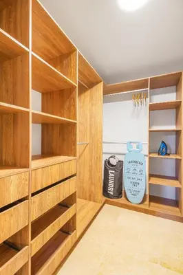 a walk in closet with wooden shelves at Edificio Boutique Alori 15-3 in Medellín