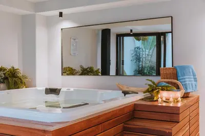 a large white tub in a bathroom with a mirror at Edificio Boutique Alori 15-3 in Medellín