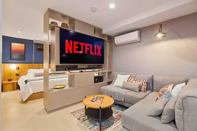 a living room with a netflix sign on the wall at Edificio Boutique Alori 15-3 in Medellín