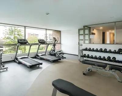 a gym with several treadmills and exercise machines at Casagrande Apartahotel in Rionegro