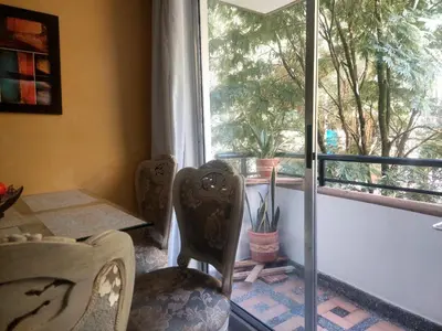 a room with a table and chairs and a window at Apartamento céntrico en el poblado in Medellín
