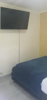 a bedroom with a bed with a blue blanket on it at Apartamento céntrico en el poblado in Medellín