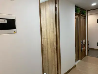 a room with a hallway with a door and a television at Centro de negocios 3 33 in Medellín