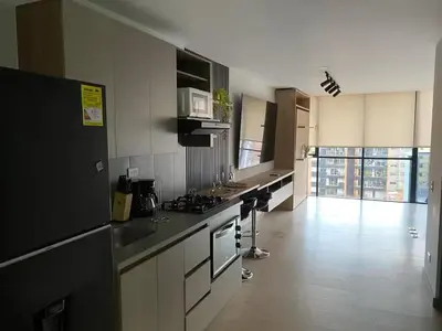 a kitchen with a stove and a counter top at Centro de negocios 3 33 in Medellín