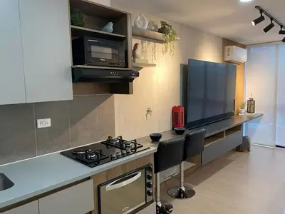 a kitchen with a stove and a counter top at Centro de negocios 3 33 in Medellín