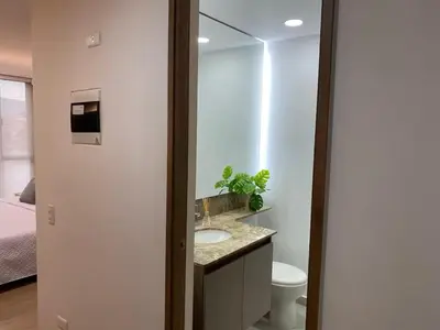 a bathroom with a sink and a toilet at Centro de negocios 3 33 in Medellín