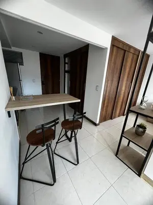 a kitchen with a table and two chairs in a room at Apartamento Loft con vista unica in Itagüí