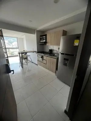 a kitchen with a stainless steel refrigerator and a tile floor at Apartamento Loft con vista unica in Itagüí
