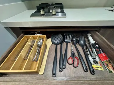 a drawer filled with cooking utensils under a counter at 1B Luxury Apartment San Javier medellin in Medellín