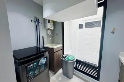 a small bathroom with a trash can and a window at 1B Luxury Apartment San Javier medellin in Medellín