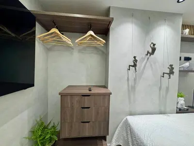 a bedroom with a bed and a wooden dresser at 1B Luxury Apartment San Javier medellin in Medellín