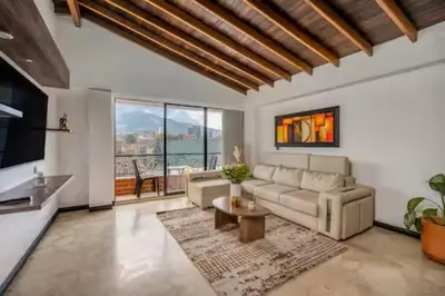 a living room with a couch and a table at Urban 5th floor Living with AC unit 3Bed3bth no elevator 5 guests max in Envigado