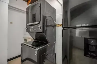a microwave oven sitting next to a refrigerator at Urban 5th floor Living with AC unit 3Bed3bth no elevator 5 guests max in Envigado