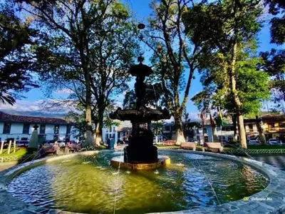 a fountain with a statue in the middle of a pond at Alojamiento Betina in Salamina