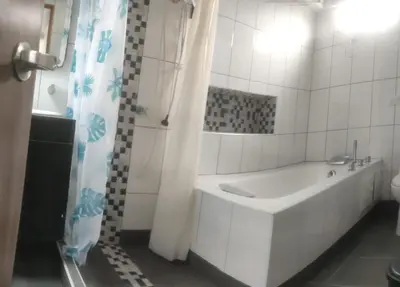a white bathroom with a tub and a shower at Alojamiento Betina in Salamina
