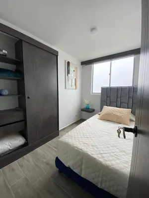 a bedroom with a large bed and a large window at Modern APT Manizales in Manizales