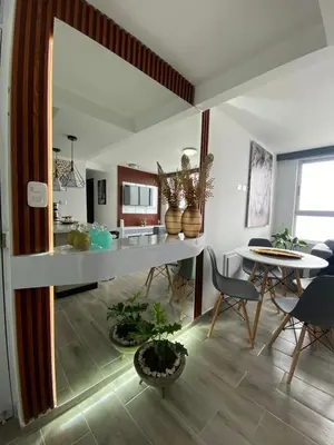 a kitchen and dining room with a table and chairs at Modern APT Manizales in Manizales