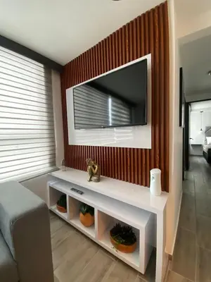 a living room with a tv on a wall at Modern APT Manizales in Manizales