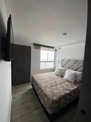 a bedroom with a bed and a television in it at Modern APT Manizales in Manizales