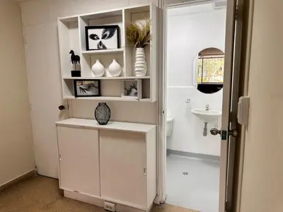 a bathroom with a white cabinet and a sink at Exclusive Group Accomodation in Medellín