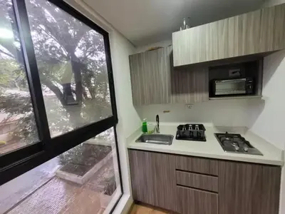 a small kitchen with a sink and a window at Laureles Garden in Medellín