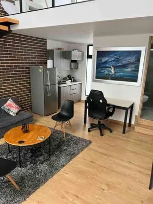 a living room with a couch and a table and chairs at Laureles Garden in Medellín