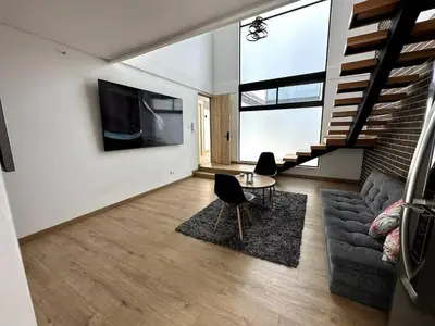 a living room with a couch and a table at Laureles Garden in Medellín