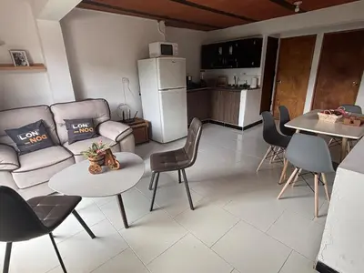 a living room with a couch and a table and chairs at Apartamento Vista Bella en la mitad de Medellin in Medellín