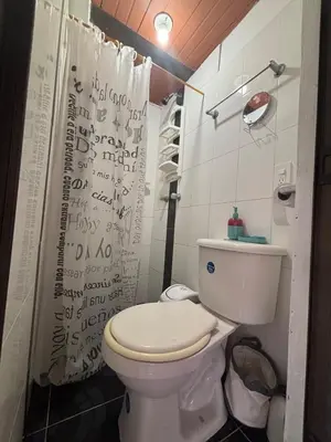 a bathroom with a toilet and a shower curtain at Apartamento Vista Bella en la mitad de Medellin in Medellín