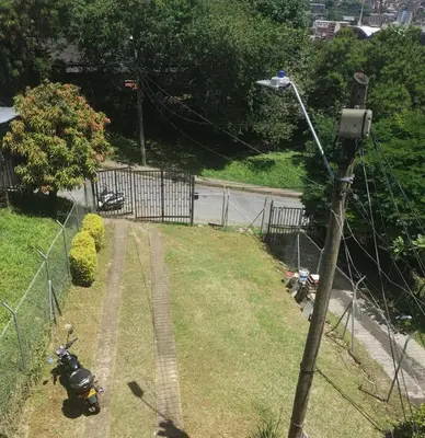 a street light with two motorcycles parked on the grass at Apartamento Vista Bella en la mitad de Medellin in Medellín