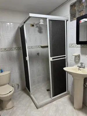 a bathroom with a shower and a toilet and a sink at Casa del parque in Bello