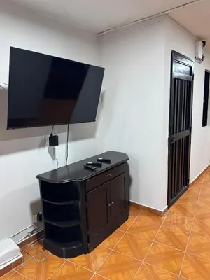 a living room with a flat screen tv on a wall at Casa del parque in Bello