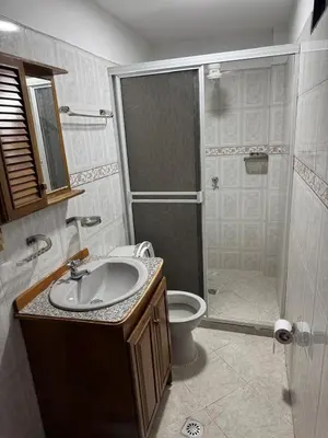 a bathroom with a shower and a sink and a toilet at Casa del parque in Bello