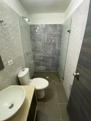 a bathroom with a toilet and a sink and a shower at Hotel La Bastida in Marinilla