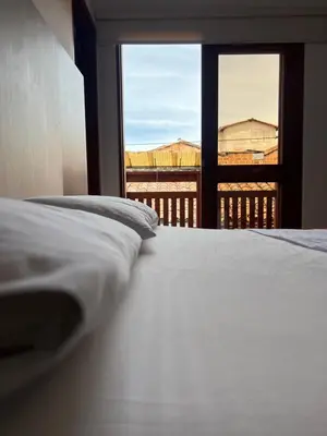 a bedroom with a bed with a view of a balcony at Hotel La Bastida in Marinilla